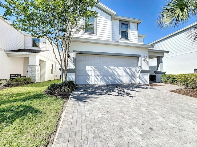 front facade with a front yard and a garage