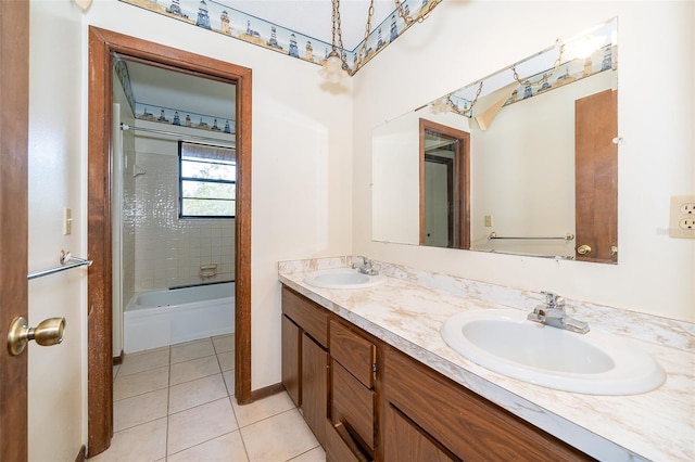 bathroom with tiled shower / bath combo, tile patterned floors, and double sink vanity