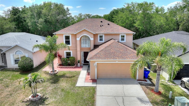 view of front of house with a garage and a front lawn