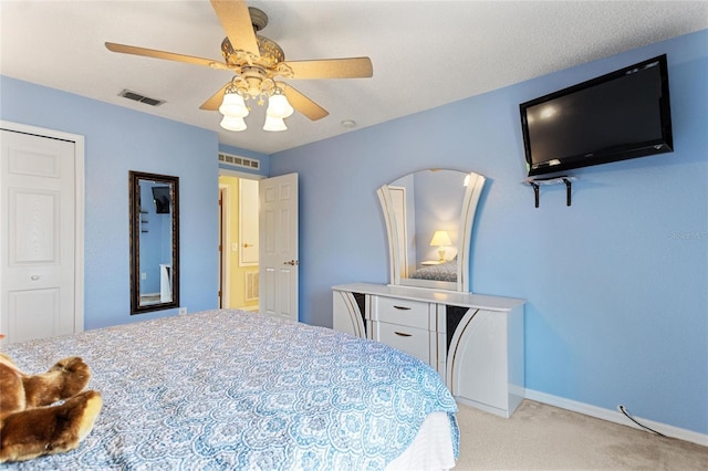 carpeted bedroom with a closet and ceiling fan