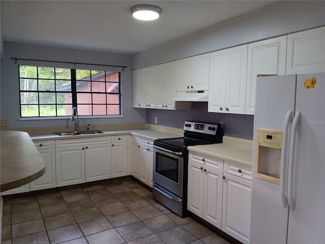 kitchen with white fridge with ice dispenser, white cabinets, sink, dark tile flooring, and stainless steel range with electric cooktop