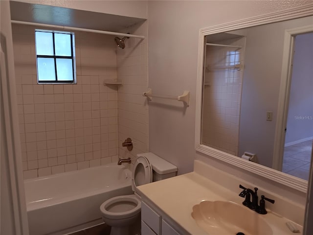 full bathroom with tiled shower / bath, toilet, and vanity