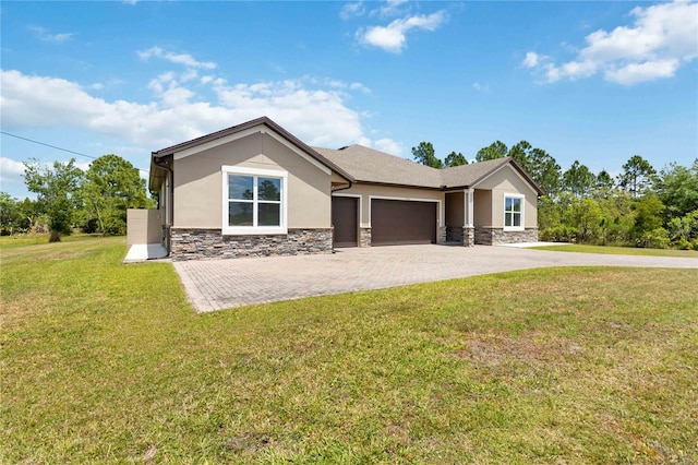 rear view of house featuring a garage and a lawn