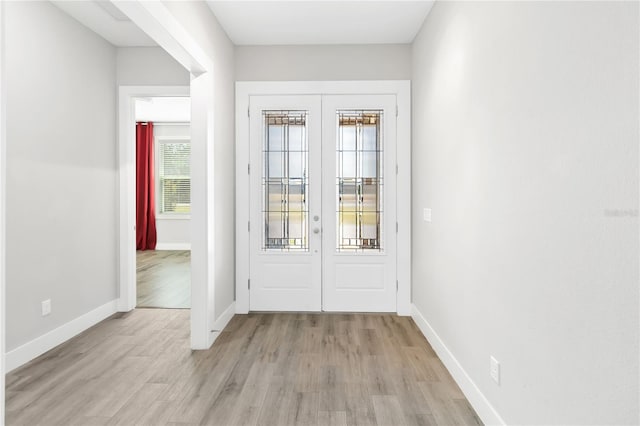 doorway with light hardwood / wood-style flooring and french doors