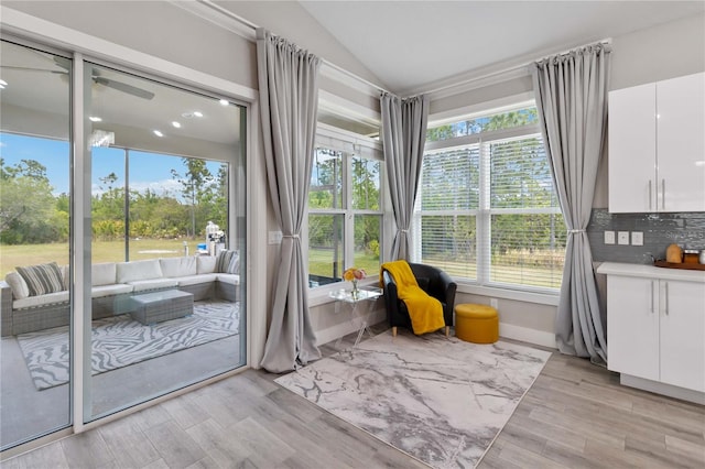 sitting room with vaulted ceiling and light hardwood / wood-style flooring