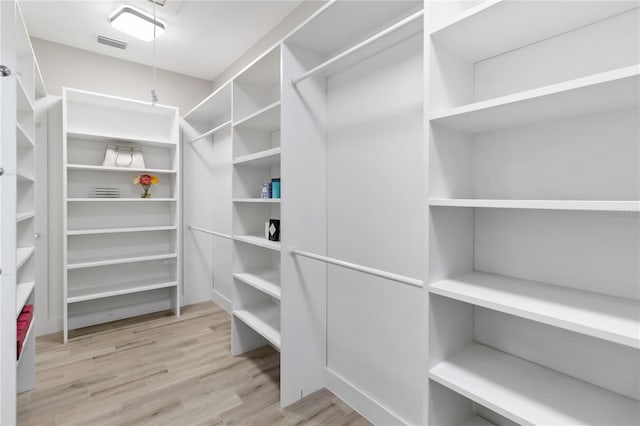 spacious closet with light hardwood / wood-style flooring