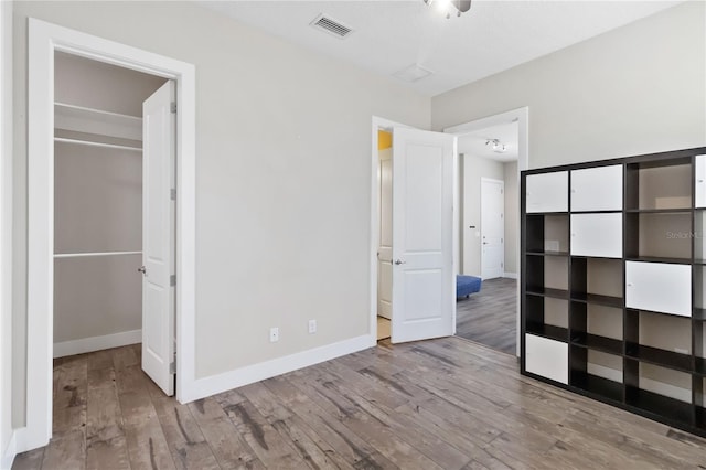 unfurnished bedroom featuring hardwood / wood-style flooring