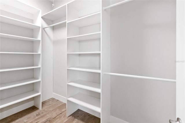 walk in closet featuring light hardwood / wood-style floors