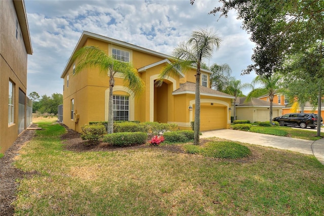 mediterranean / spanish house with a garage and a front lawn