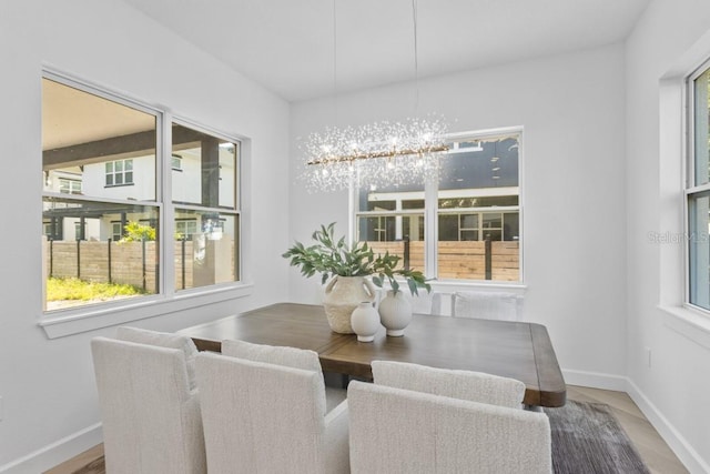 dining space with a notable chandelier and wood-type flooring