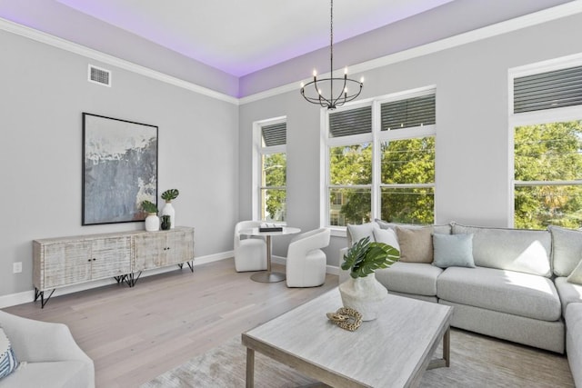 living room with a chandelier and light hardwood / wood-style flooring