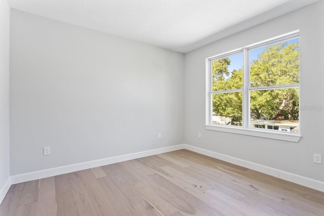 spare room with light hardwood / wood-style flooring