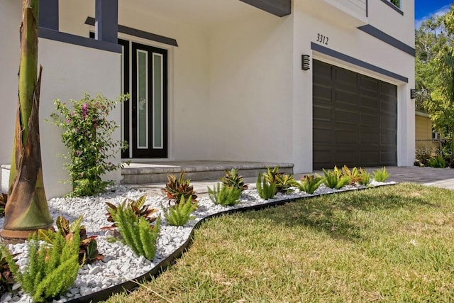 exterior space featuring a garage and a lawn