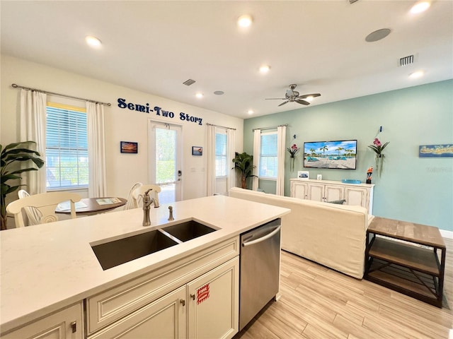 kitchen featuring sink, ceiling fan, stainless steel dishwasher, and light wood-type flooring