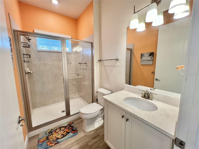 bathroom featuring walk in shower, toilet, oversized vanity, and hardwood / wood-style floors