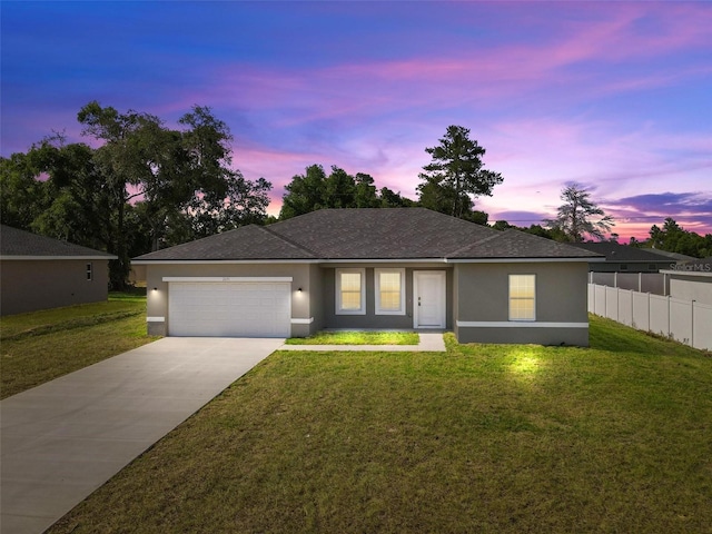 view of front of home featuring a yard and a garage