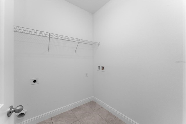 clothes washing area featuring tile flooring, electric dryer hookup, and washer hookup