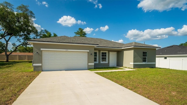 view of front of home with a garage and a front lawn