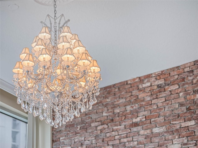 details with ornamental molding and a notable chandelier