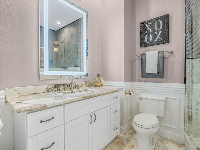 bathroom featuring vanity, toilet, and an enclosed shower