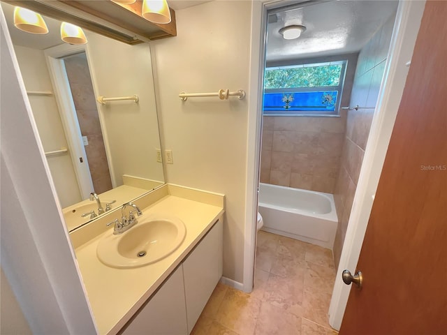 full bathroom with oversized vanity, tile floors, toilet, and tiled shower / bath