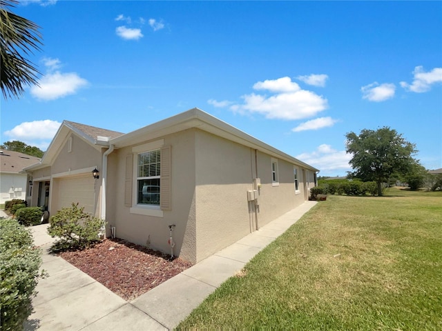 view of property exterior featuring a garage and a yard