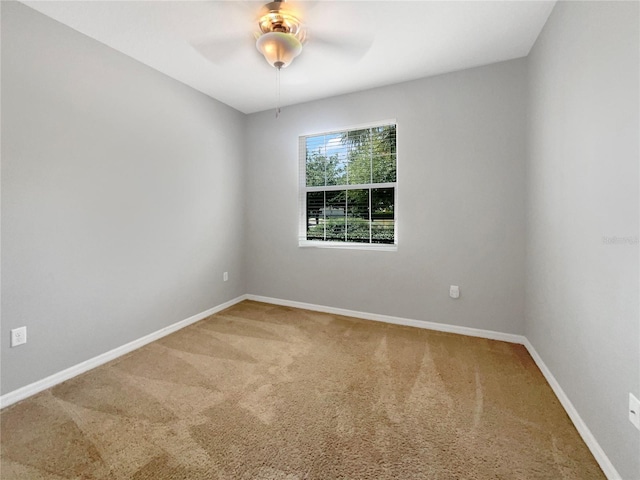 spare room featuring ceiling fan and carpet