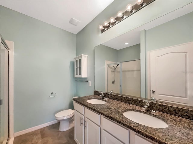 bathroom featuring walk in shower, tile flooring, toilet, and dual sinks