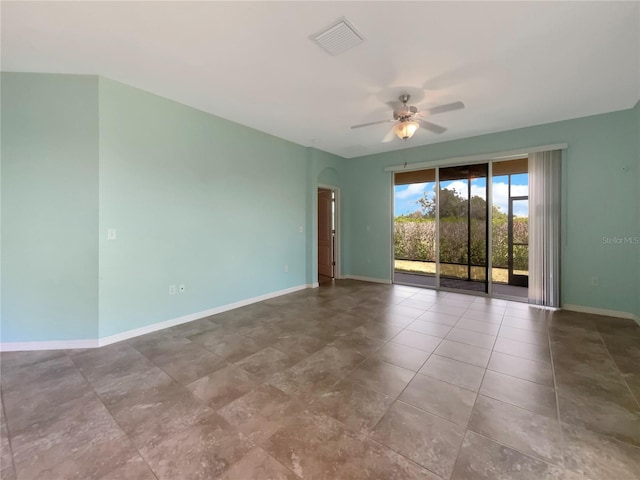 tiled empty room with ceiling fan