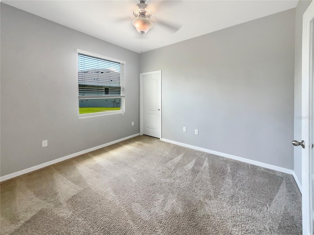 spare room featuring ceiling fan and carpet