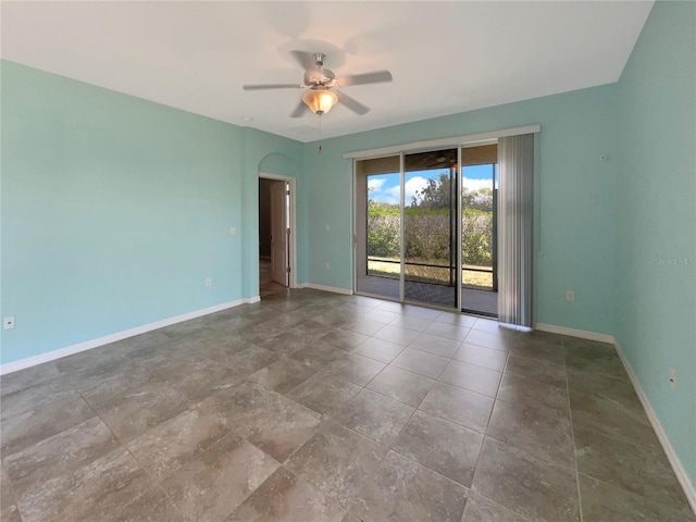 tiled empty room with ceiling fan