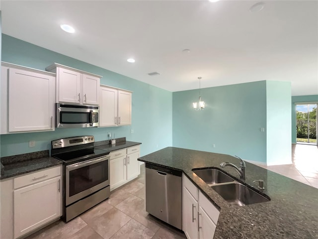 kitchen featuring sink, white cabinetry, stainless steel appliances, and light tile floors