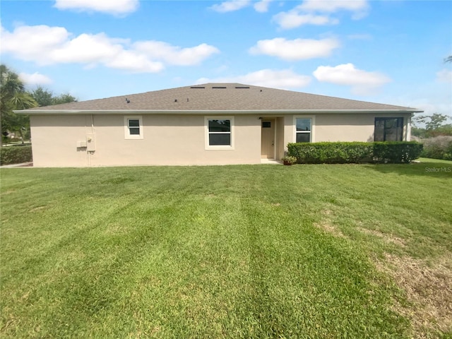 33083 Windelstraw Dr, Wesley Chapel, FL 33545 - back of property with a yard and stucco siding