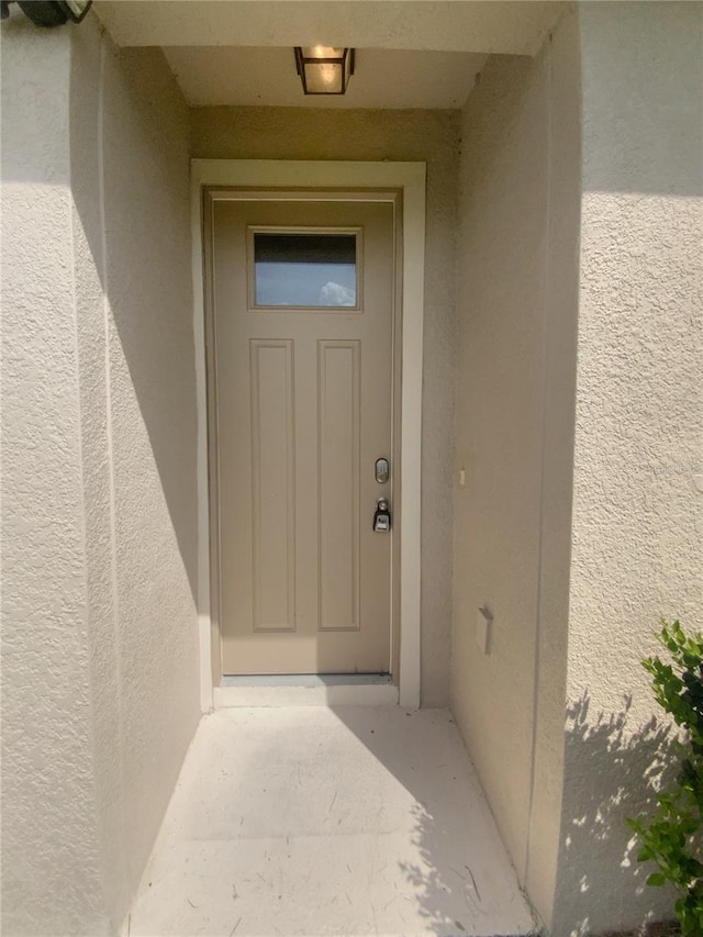 33083 Windelstraw Dr, Wesley Chapel, FL 33545 - view of exterior entry featuring stucco siding