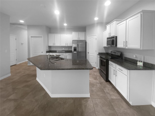 33083 Windelstraw Dr, Wesley Chapel, FL 33545 - kitchen with appliances with stainless steel finishes, white cabinetry, a kitchen island with sink, recessed lighting, and dark stone counters