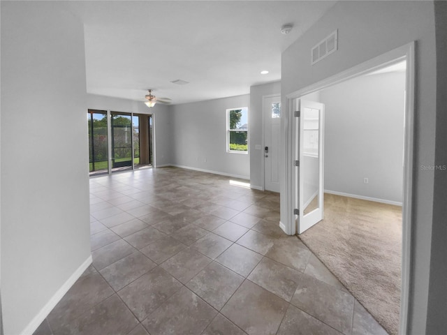 33083 Windelstraw Dr, Wesley Chapel, FL 33545 - tiled spare room featuring healthy amount of natural light, a smoke detector, ceiling fan, recessed lighting, and carpet