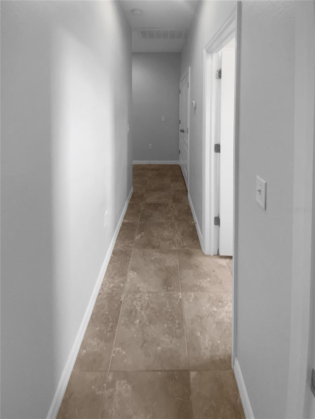 33083 Windelstraw Dr, Wesley Chapel, FL 33545 - hallway featuring stone finish flooring and baseboards
