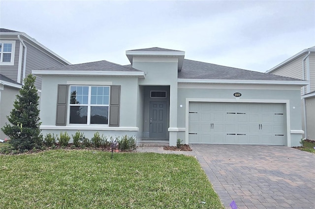 view of front facade with a garage and a front lawn