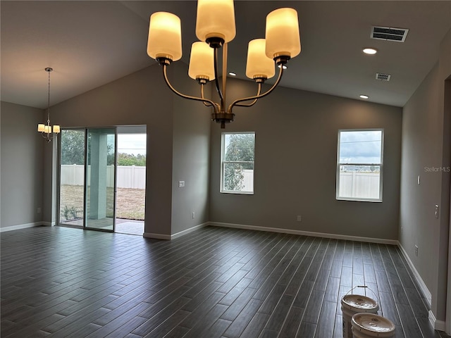 empty room featuring dark hardwood / wood-style floors, vaulted ceiling, and a notable chandelier