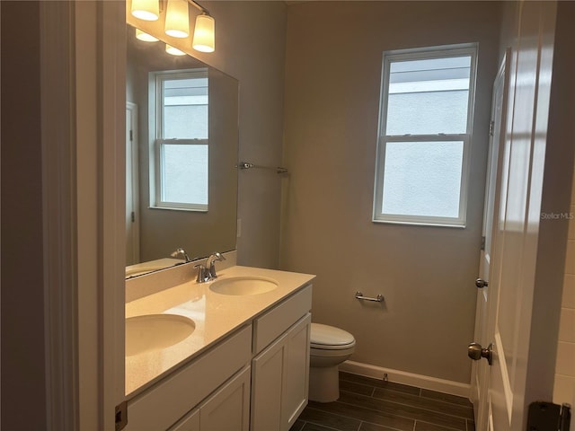 bathroom featuring vanity and toilet