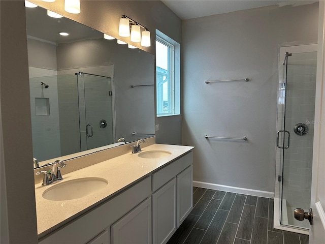 bathroom with vanity and a shower with door