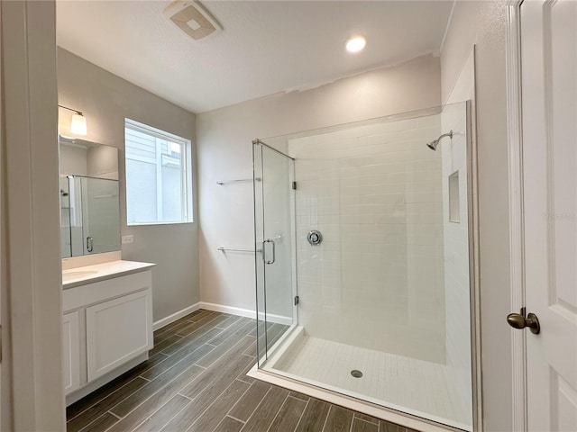 bathroom featuring vanity and an enclosed shower