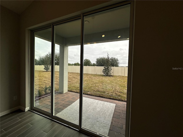 doorway to outside featuring dark wood-type flooring