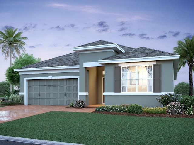 view of front of house featuring a garage and a lawn