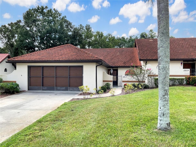 view of front of property with a garage and a front lawn