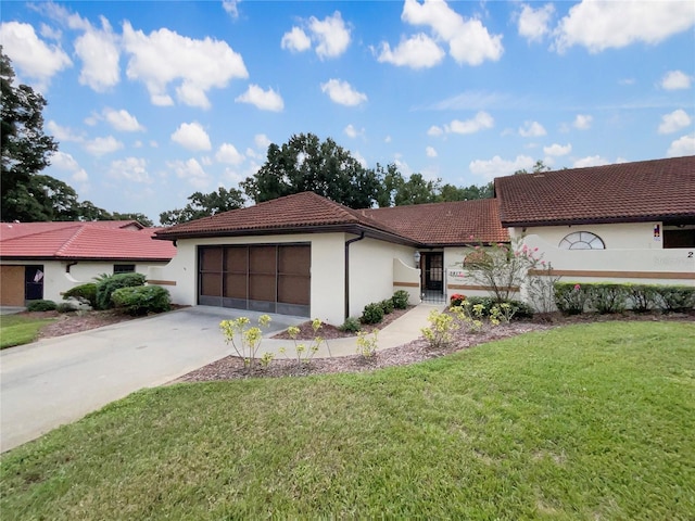 view of front of home featuring a garage and a front yard