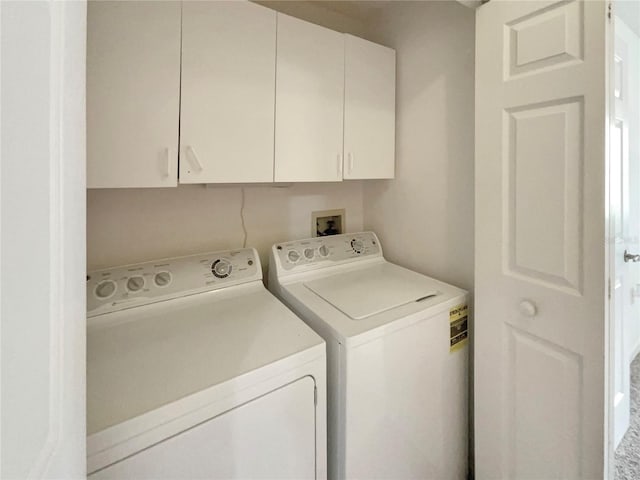 laundry area featuring cabinets and washing machine and dryer