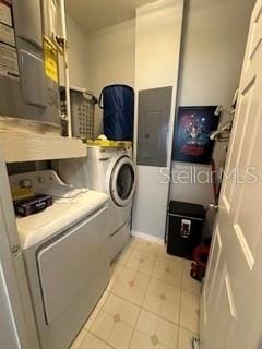 washroom featuring washing machine and clothes dryer and light tile floors