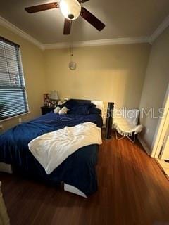 bedroom with hardwood / wood-style floors, ceiling fan, and crown molding