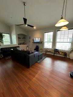 unfurnished living room featuring wood-type flooring, ceiling fan, and vaulted ceiling